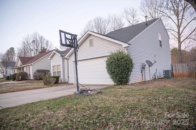 view of property exterior with central air condition unit, driveway, fence, a yard, and an attached garage