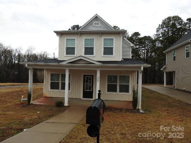 view of front facade with covered porch and board and batten siding