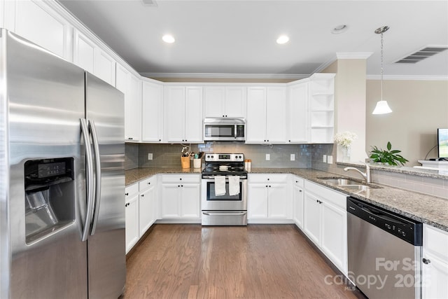 kitchen with visible vents, white cabinets, appliances with stainless steel finishes, pendant lighting, and a sink