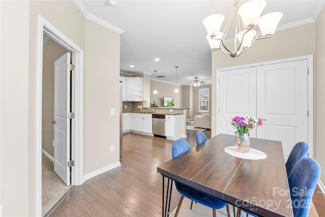 dining area featuring recessed lighting, ceiling fan with notable chandelier, wood finished floors, baseboards, and crown molding