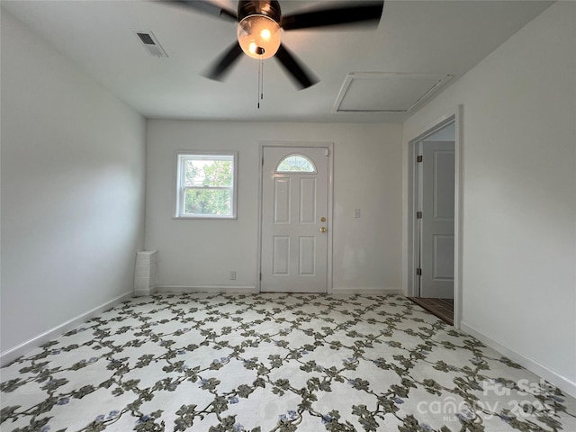 foyer entrance with visible vents and baseboards