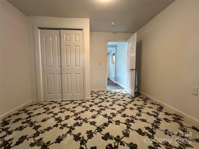 unfurnished bedroom featuring a closet and baseboards