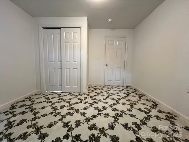 bedroom featuring baseboards and a closet