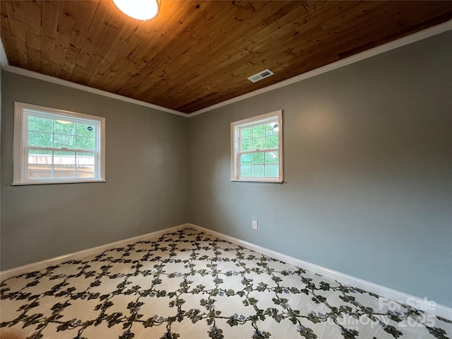 empty room with ornamental molding, wooden ceiling, visible vents, and baseboards