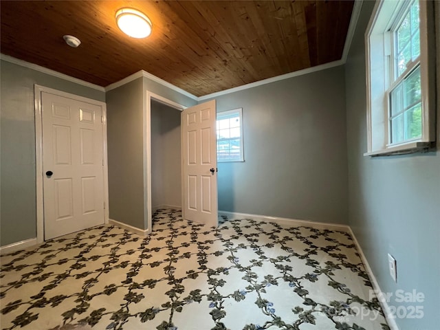 unfurnished bedroom featuring wood ceiling, ornamental molding, and baseboards