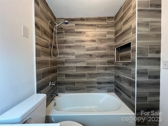 bathroom featuring shower / tub combination and toilet