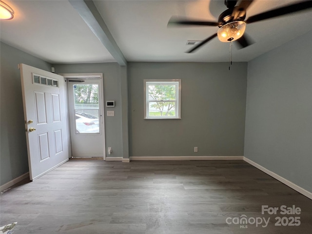 foyer entrance featuring visible vents, baseboards, and wood finished floors