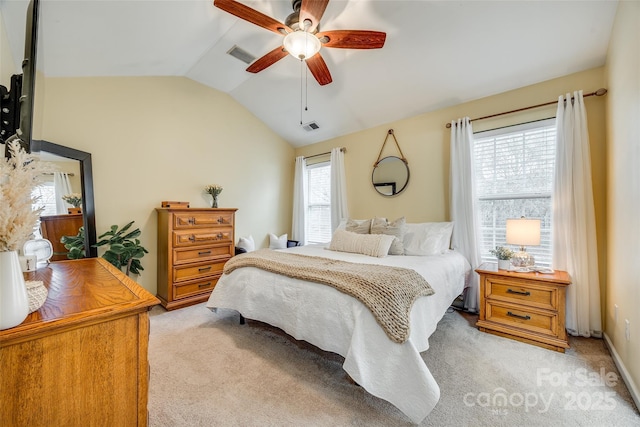 bedroom featuring lofted ceiling, ceiling fan, light carpet, and visible vents