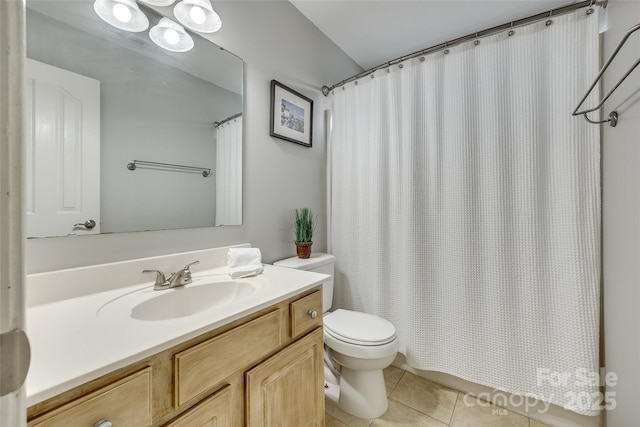 bathroom featuring tile patterned flooring, a shower with shower curtain, vanity, and toilet