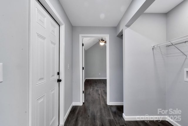 hallway featuring dark wood-style floors and baseboards