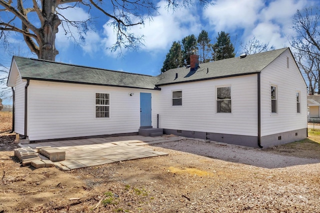 back of property featuring roof with shingles, a chimney, entry steps, crawl space, and a patio area