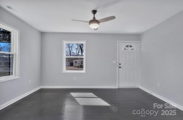 entryway featuring ceiling fan, baseboards, and dark wood-type flooring