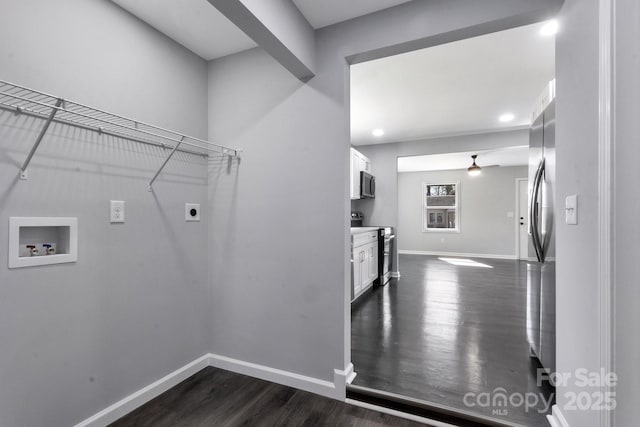 clothes washing area with laundry area, baseboards, dark wood-style floors, hookup for a washing machine, and electric dryer hookup