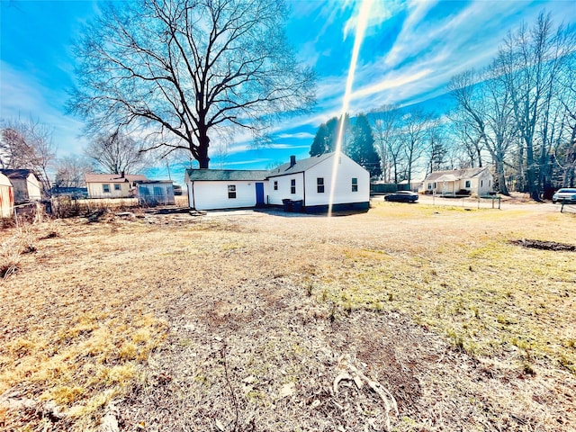 exterior space featuring fence and a front lawn