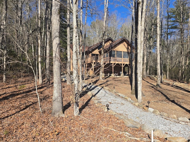 view of front facade featuring a wooden deck and a sunroom