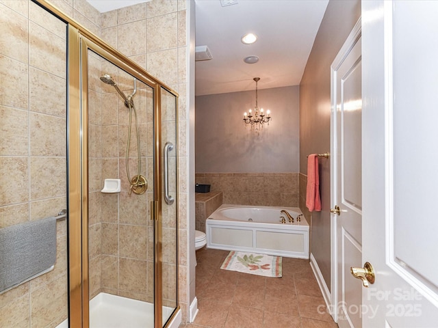 bathroom featuring a stall shower, tile patterned flooring, a notable chandelier, and a bath