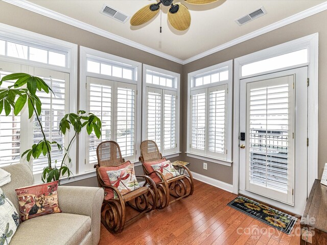 sunroom featuring ceiling fan and visible vents