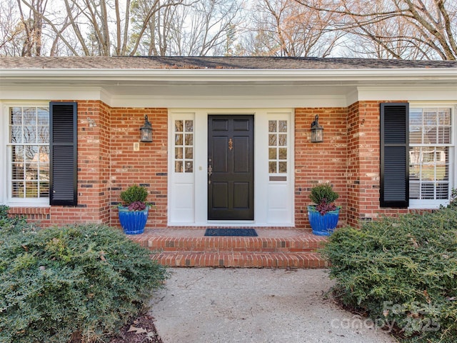 property entrance featuring brick siding