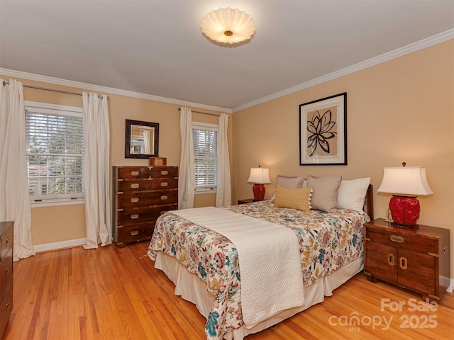 bedroom featuring crown molding, baseboards, and wood finished floors