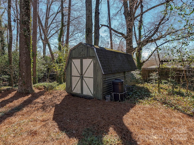 view of shed featuring fence