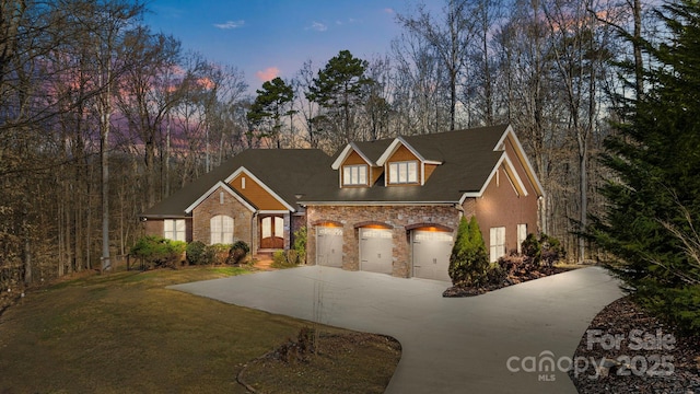 view of front of property with a garage, a front lawn, and concrete driveway