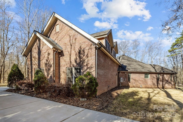 view of property exterior with brick siding