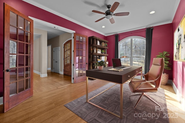 office area featuring arched walkways, french doors, ornamental molding, wood finished floors, and baseboards