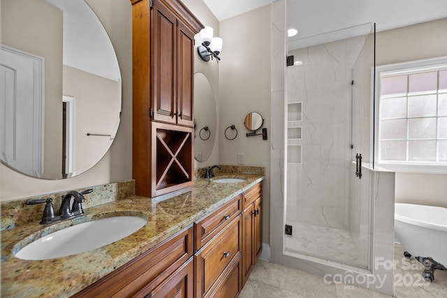 bathroom featuring double vanity, a stall shower, a freestanding bath, and a sink