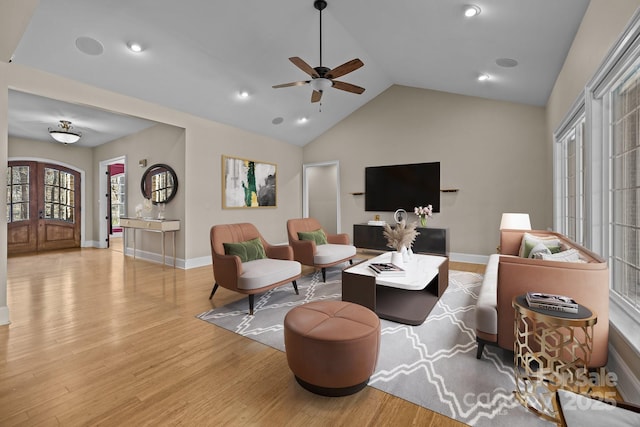 living area with recessed lighting, vaulted ceiling, baseboards, and wood finished floors