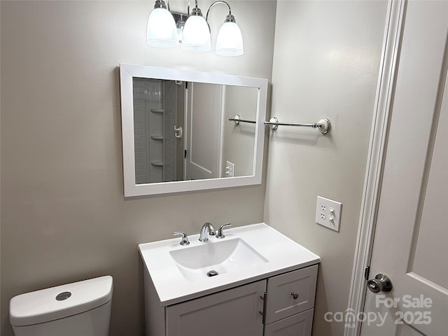 bathroom featuring toilet and vanity