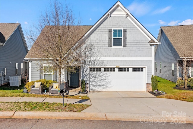 traditional-style home with driveway, an attached garage, and central air condition unit