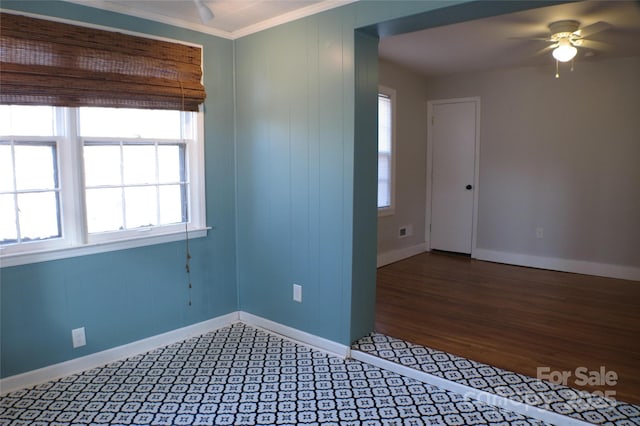 unfurnished room featuring ornamental molding, ceiling fan, and baseboards