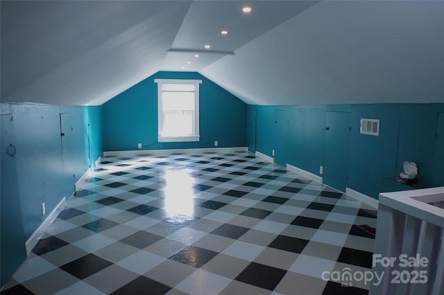 additional living space with lofted ceiling, visible vents, baseboards, and recessed lighting