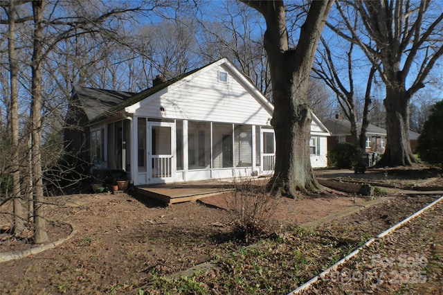 rear view of property with a sunroom