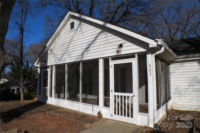 view of side of property featuring a sunroom