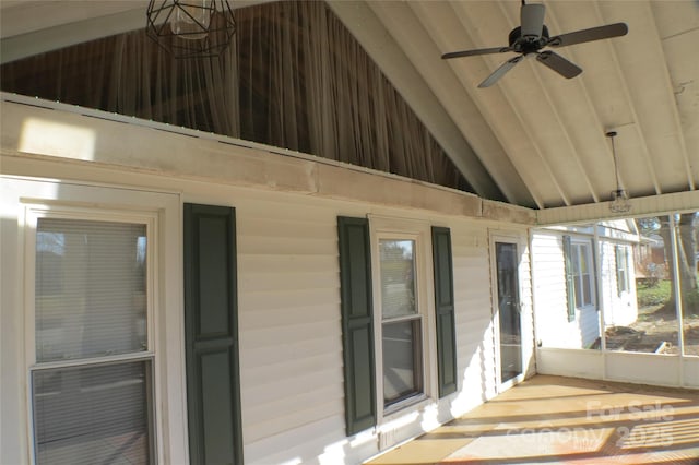 unfurnished sunroom featuring ceiling fan and vaulted ceiling