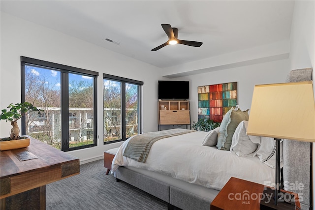 carpeted bedroom featuring ceiling fan, visible vents, and baseboards