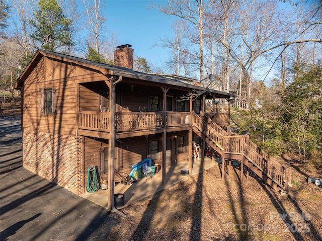 exterior space featuring driveway and stairs