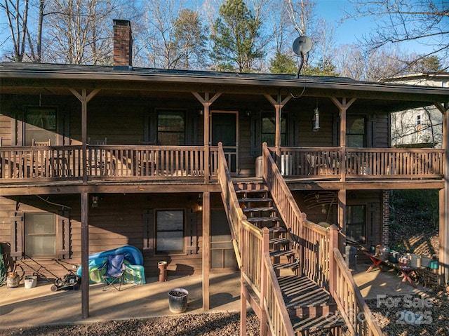 view of front of property featuring stairway and a chimney