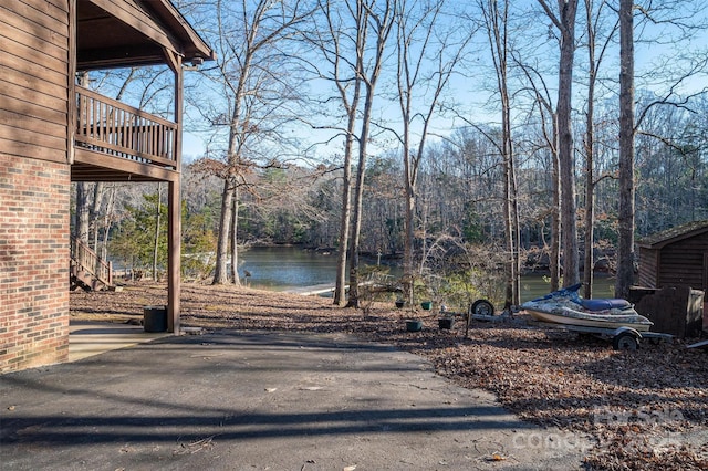 exterior space featuring a water view and driveway