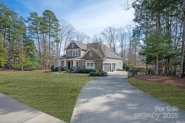 view of front of house with a garage, driveway, and a front lawn