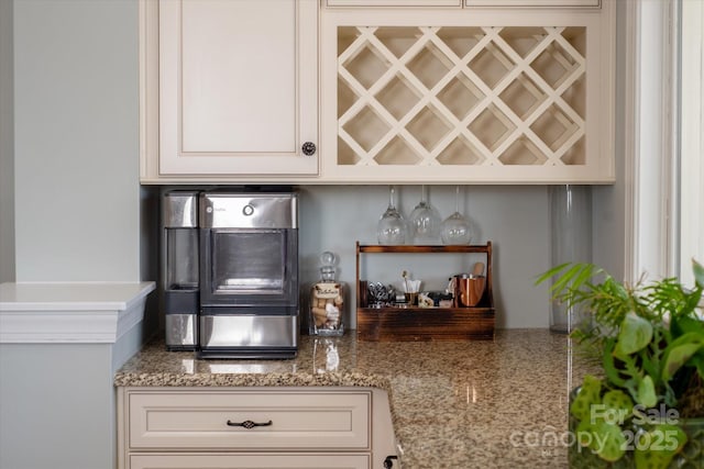 kitchen featuring white cabinets and light stone countertops