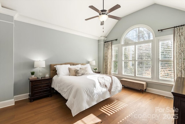 bedroom featuring baseboards, vaulted ceiling, and wood finished floors