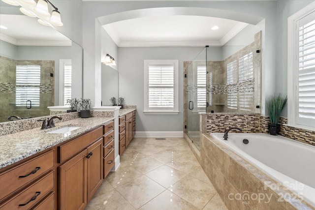 full bath with tile patterned flooring, vanity, baseboards, a shower stall, and crown molding