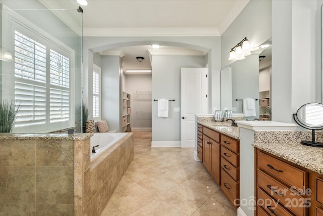 bathroom featuring ornamental molding, a garden tub, tile patterned flooring, a spacious closet, and vanity