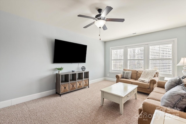 carpeted living room featuring ceiling fan and baseboards