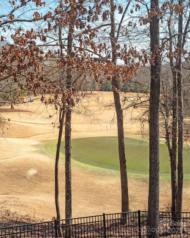 view of home's community with fence and golf course view