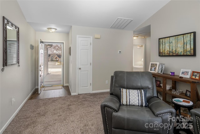 entrance foyer with vaulted ceiling, carpet, visible vents, and baseboards