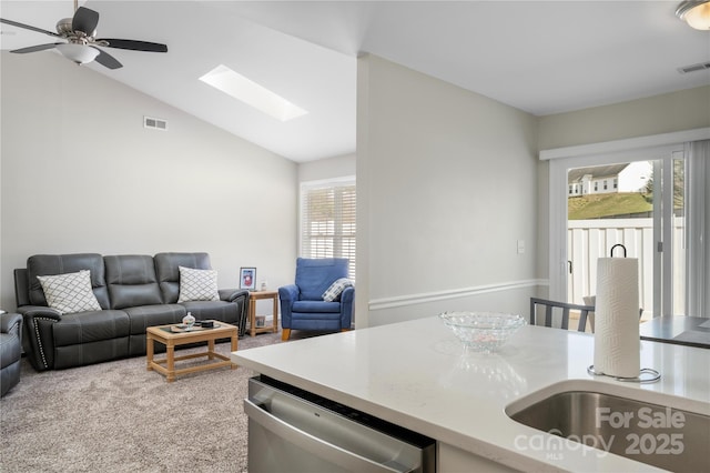 kitchen featuring dishwasher, light countertops, open floor plan, and visible vents