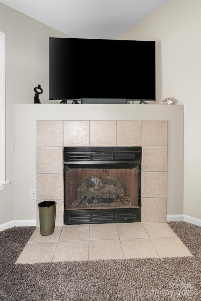 interior details featuring carpet floors, a fireplace, and baseboards